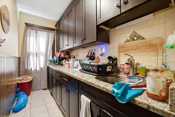 a kitchen with stainless steel appliances granite countertop a sink stove and cabinets