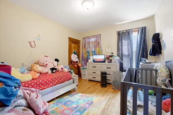 a bedroom with baby bed furniture and a window