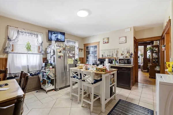 a view of a kitchen with fridge and workspace