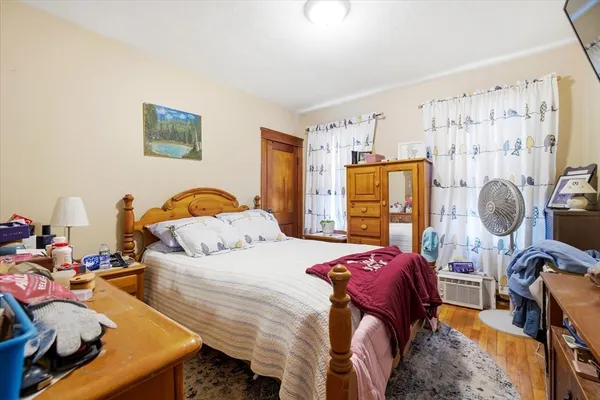 a bedroom with bed and a window