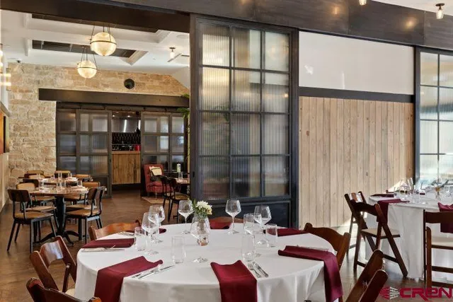 a view of a dining room with furniture and chandelier