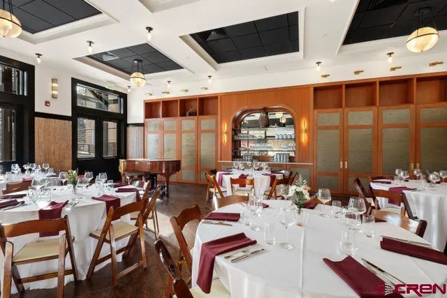 a very nice looking room with a large window and chairs