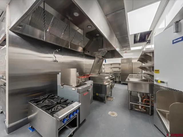 a kitchen with a stove and a refrigerator
