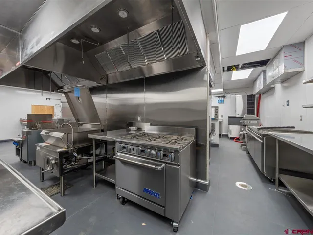 a stove top oven sitting inside of a kitchen