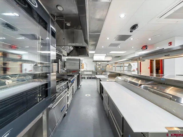 a kitchen with stainless steel appliances lots of counter top space