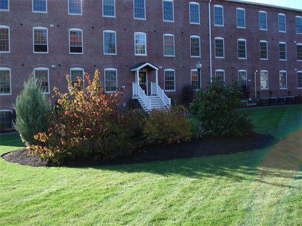 25 Cedar Street, Unit 3 Amesbury, MA 01913 - Photo 11 of 13 a front view of a building with garden
