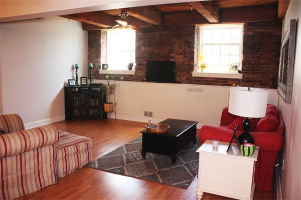 25 Cedar Street, Unit 3 Amesbury, MA 01913 - Photo 2 of 13 a living room with furniture and a flat screen tv