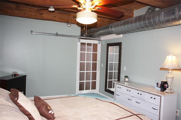 25 Cedar Street, Unit 3 Amesbury, MA 01913 - Photo 4 of 13 a bedroom with a bed and a chandelier