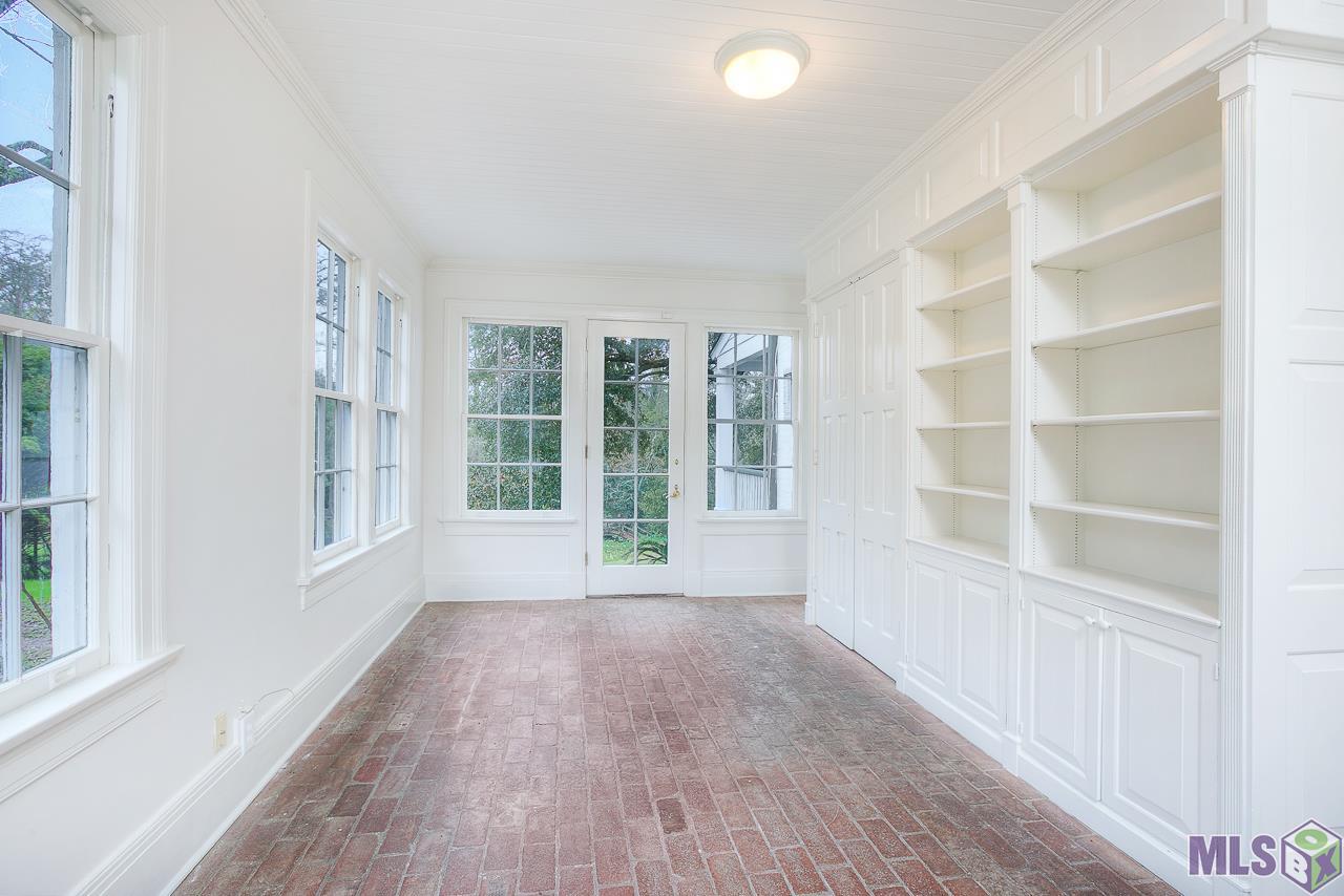 4756 Highland Road Baton Rouge, LA 70808 - Photo 18 of 42 Sunroom W/ Views of Garden; Pond & Bridge Leading to Dawson's Creek
