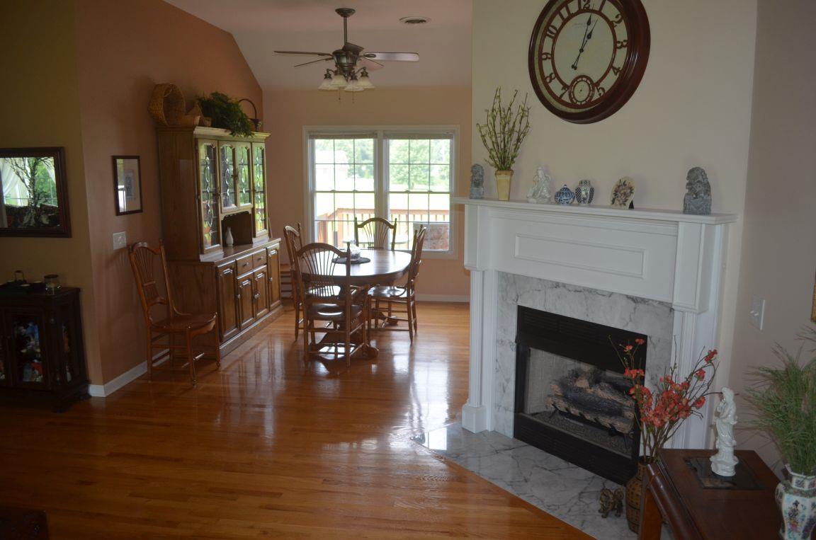 2790 Woods Road Springfield, TN 37172 - Photo 5 of 30 a living room with furniture a clock and a fireplace