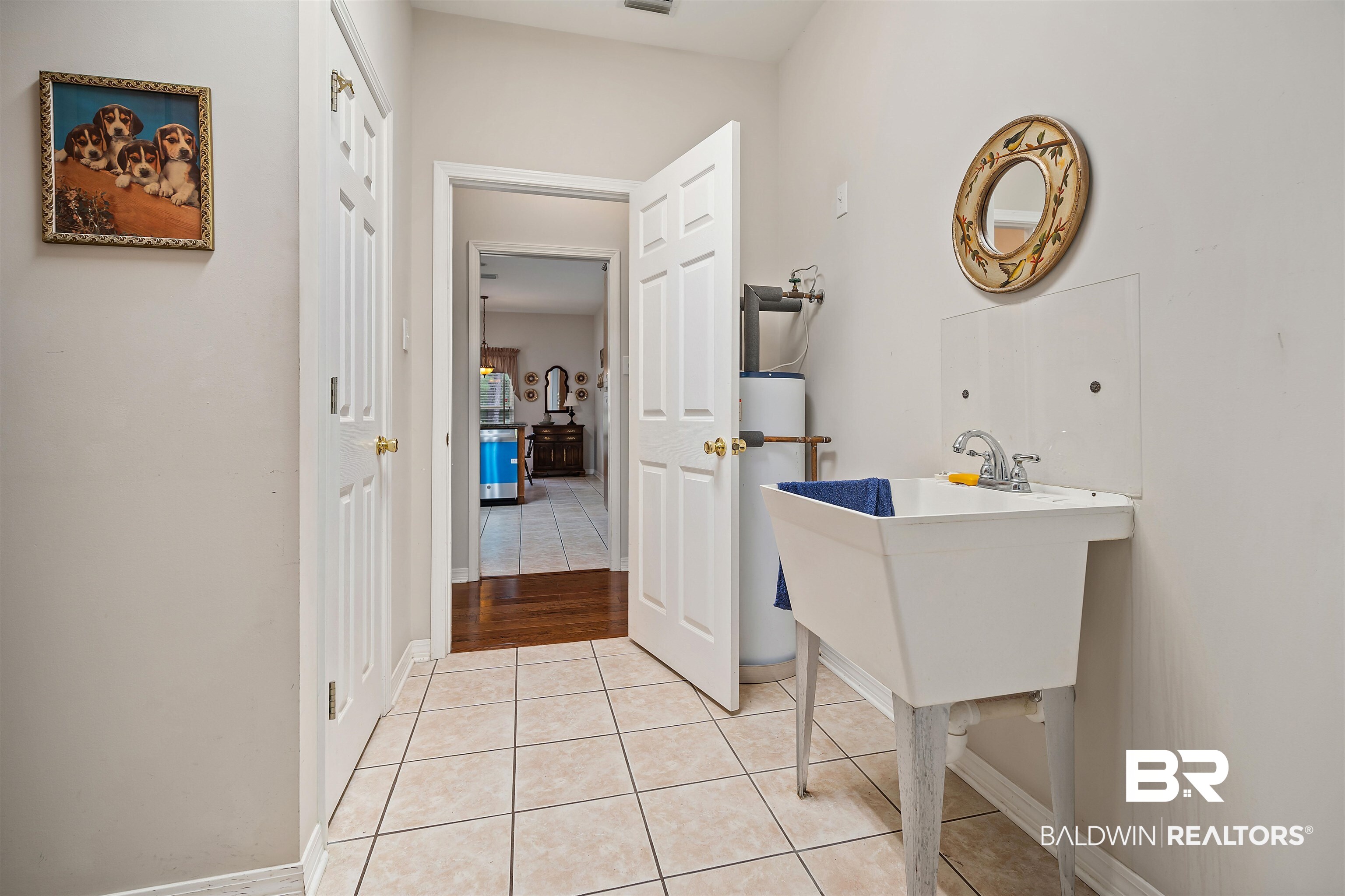 7419 Pake Road Saraland, AL 36571 - Photo 22 of 27 Bathroom with tile patterned floors, gas water heater, and sink