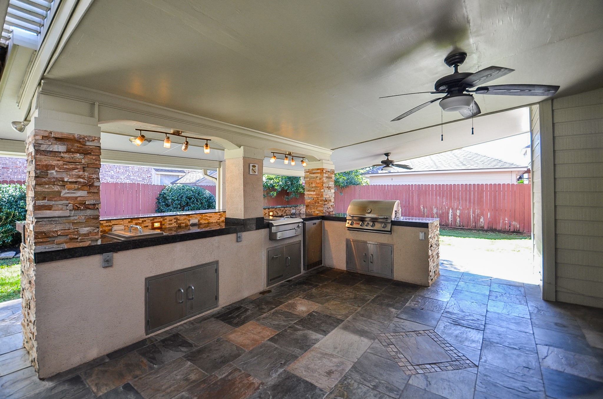 8803 Tweedbrook Drive Spring, TX 77379 - Photo 30 of 36 Step out onto this expansive and beautiful covered patio with an outdoor kitchen.