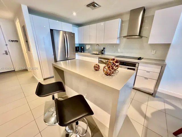 a living room with furniture a flat screen tv and a floor to ceiling window