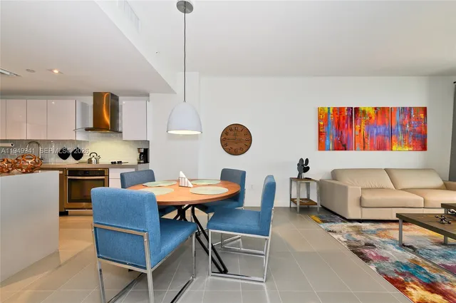a view of a dining room with furniture and a kitchen
