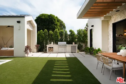 a view of a chair and tables in the patio