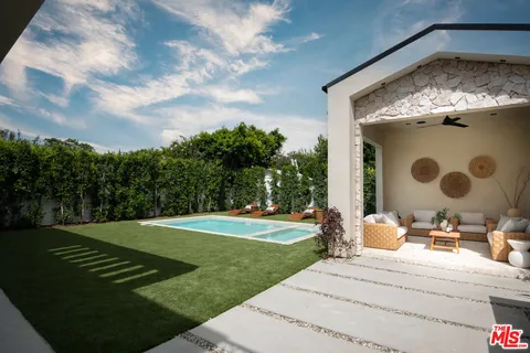 a backyard of a house with yard and trampoline