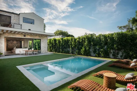 a view of a backyard with sitting area