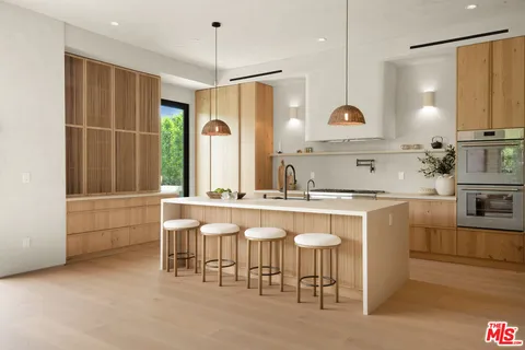 a large kitchen with a lot of counter space and a sink