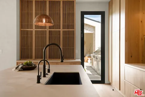 a view of a sink and a window in a bathroom