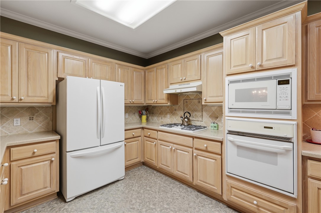 1520 Bennett Street Bryan, TX 77802 - Photo 10 of 24 a white refrigerator freezer sitting in a kitchen