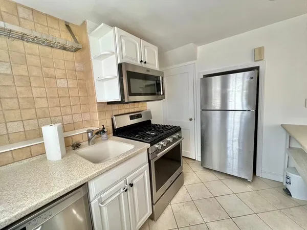 a kitchen with a sink a stove and refrigerator