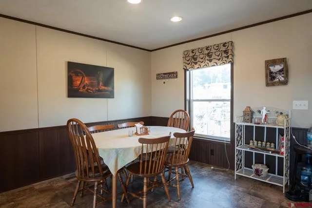 a view of a dining room with furniture and window