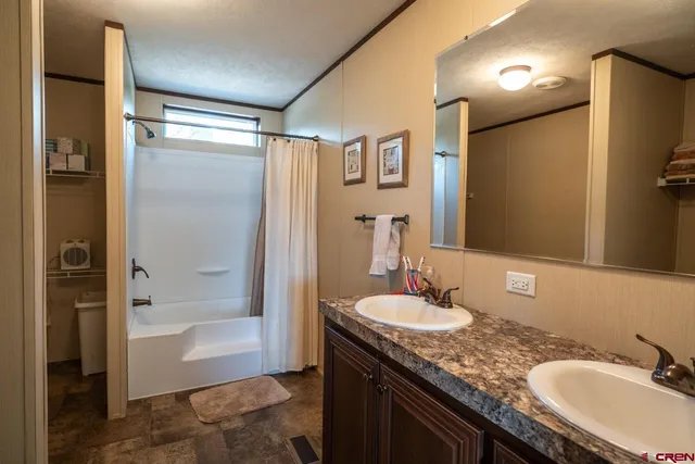 a bathroom with a granite countertop sink mirror bathtub and shower