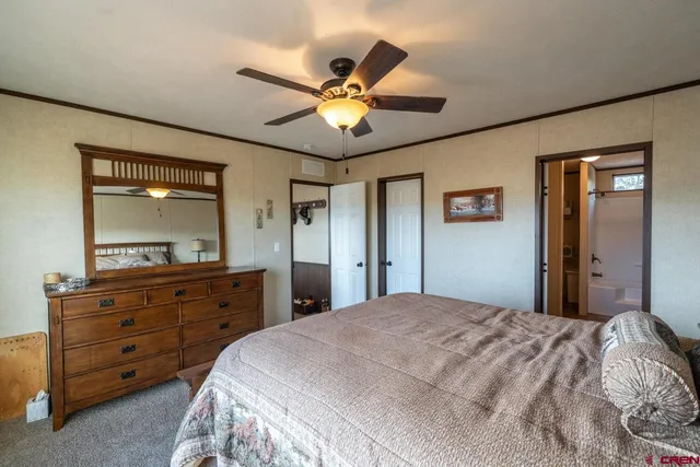 a bedroom with a bed and a mirror on dresser