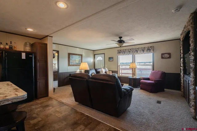 a living room with furniture a window and a flat screen tv