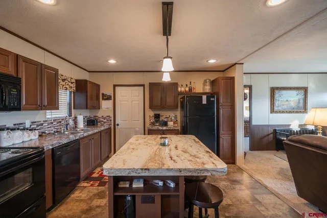 a large kitchen with a table and chairs
