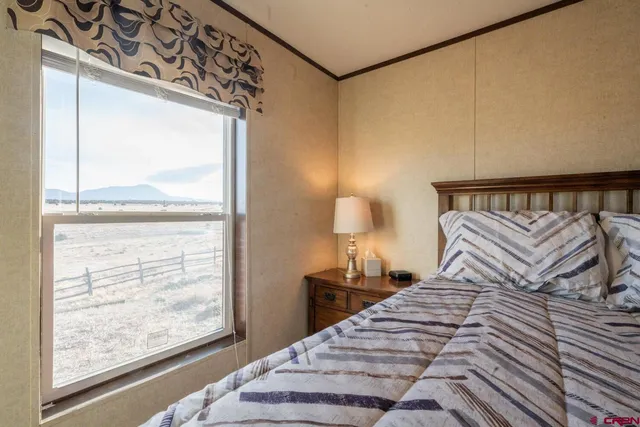 a bedroom with a bed and a night stand