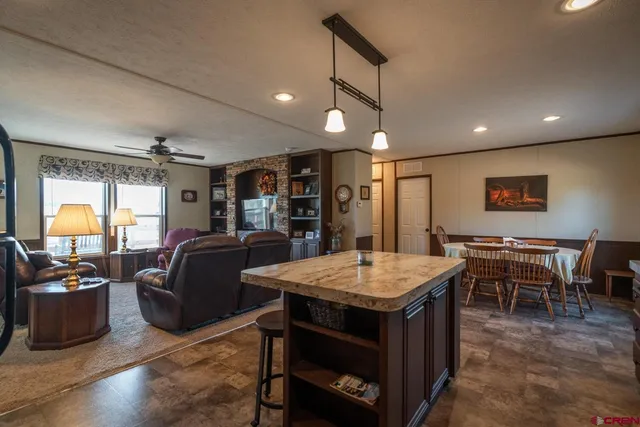 a room with furniture a flat screen tv and a large window