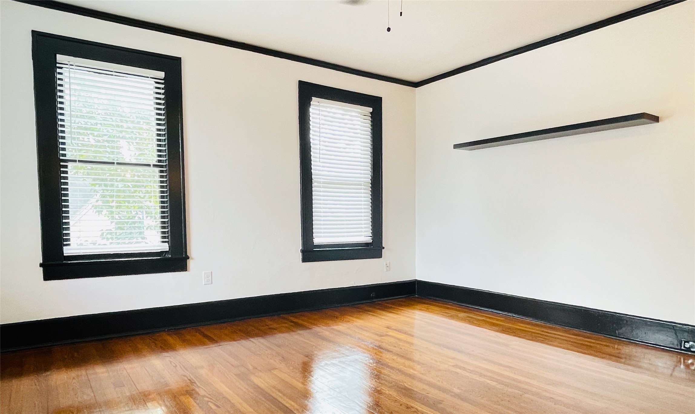 614 Peden Street, Unit B Houston, TX 77006 - Photo 2 of 11 a view of an empty room with wooden floor and a window