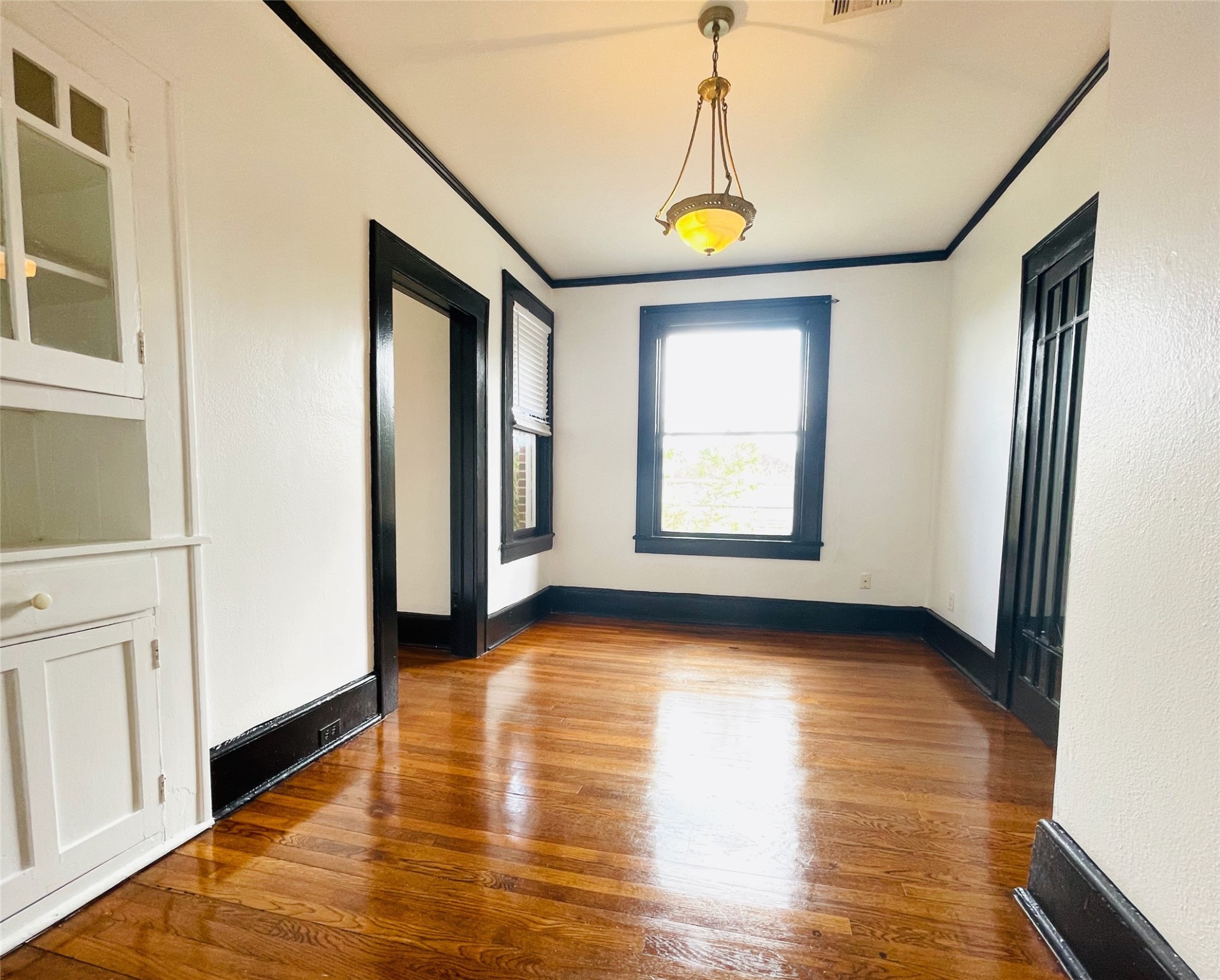 614 Peden Street, Unit B Houston, TX 77006 - Photo 4 of 11 a view of an empty room with window and wooden floor