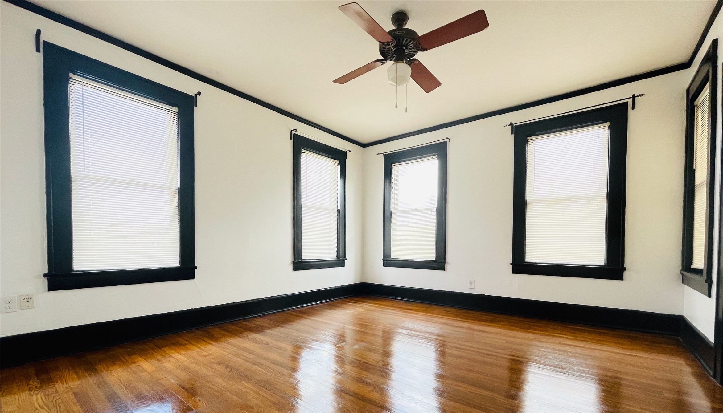 614 Peden Street, Unit B Houston, TX 77006 - Photo 9 of 11 a view of an empty room with a window and wooden floor