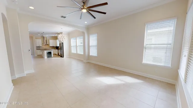 a view of a livingroom with a ceiling fan and window