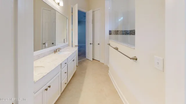 a bathroom with a double vanity sink and mirror