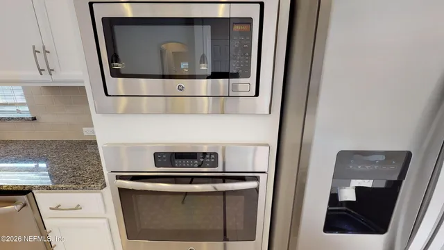 a stove top oven sitting inside of a kitchen