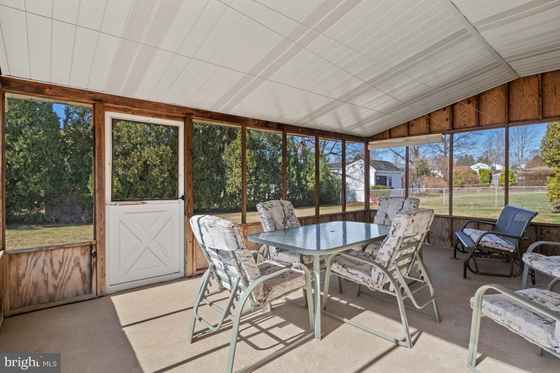 1538 Windmill Road Warminster, PA 18974 - Photo 29 of 32 a view of a dining room with furniture large windows and wooden floor