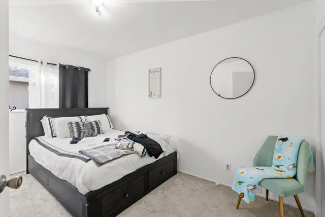 a bed room with a bed and chair