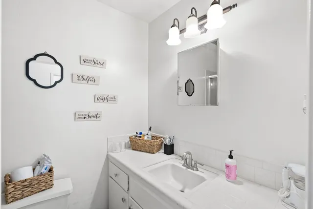 a bathroom with a sink and a mirror