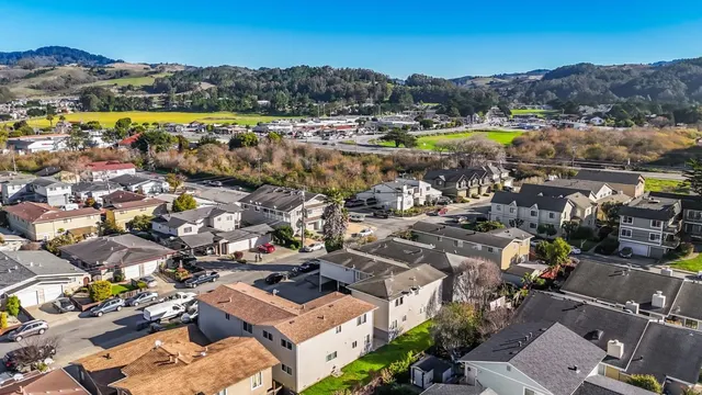 an aerial view of a house with a yard