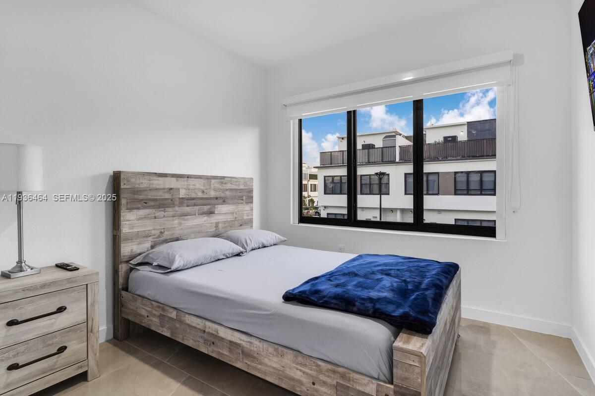 14502 Southwest 260th Street Homestead, FL 33032 - Photo 3 of 8 a bedroom with a bed and a large window