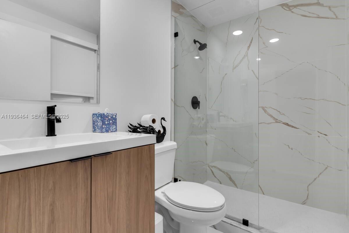 14502 Southwest 260th Street Homestead, FL 33032 - Photo 7 of 8 a bathroom with a sink a toilet and shower