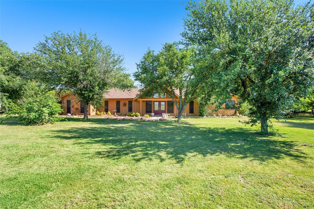 7146 Refuge Road Pottsboro, TX 75076 - Photo 11 of 39 a front view of a house with a garden