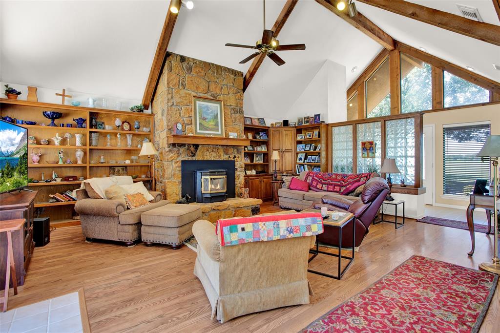 7146 Refuge Road Pottsboro, TX 75076 - Photo 20 of 39 a living room with furniture a fireplace and a table