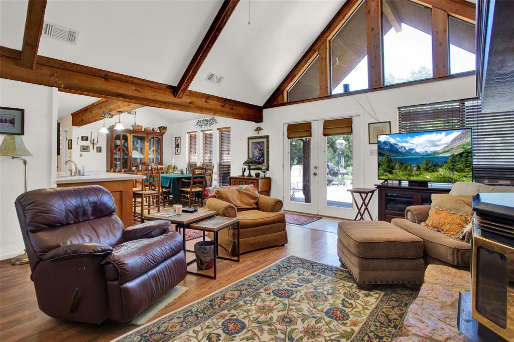 7146 Refuge Road Pottsboro, TX 75076 - Photo 22 of 39 a living room with furniture fireplace and a large window