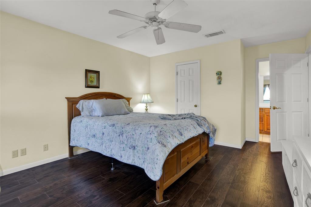 7146 Refuge Road Pottsboro, TX 75076 - Photo 27 of 39 a bedroom with a bed and wooden floor
