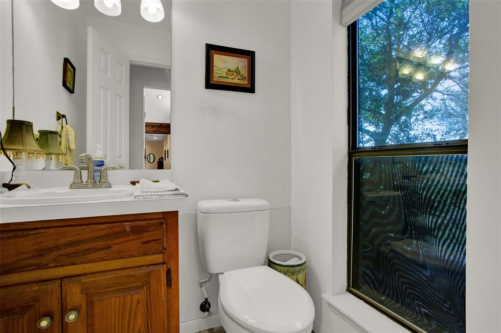 7146 Refuge Road Pottsboro, TX 75076 - Photo 30 of 39 a bathroom with a sink a toilet and shower