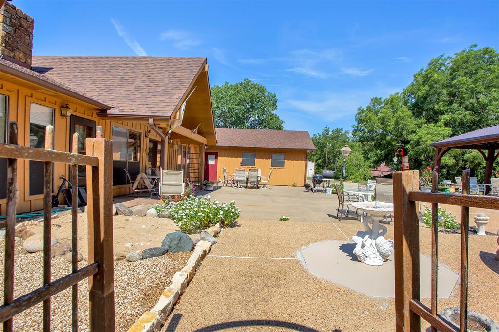 7146 Refuge Road Pottsboro, TX 75076 - Photo 3 of 39 a view of a patio with couches table and chairs and potted plants